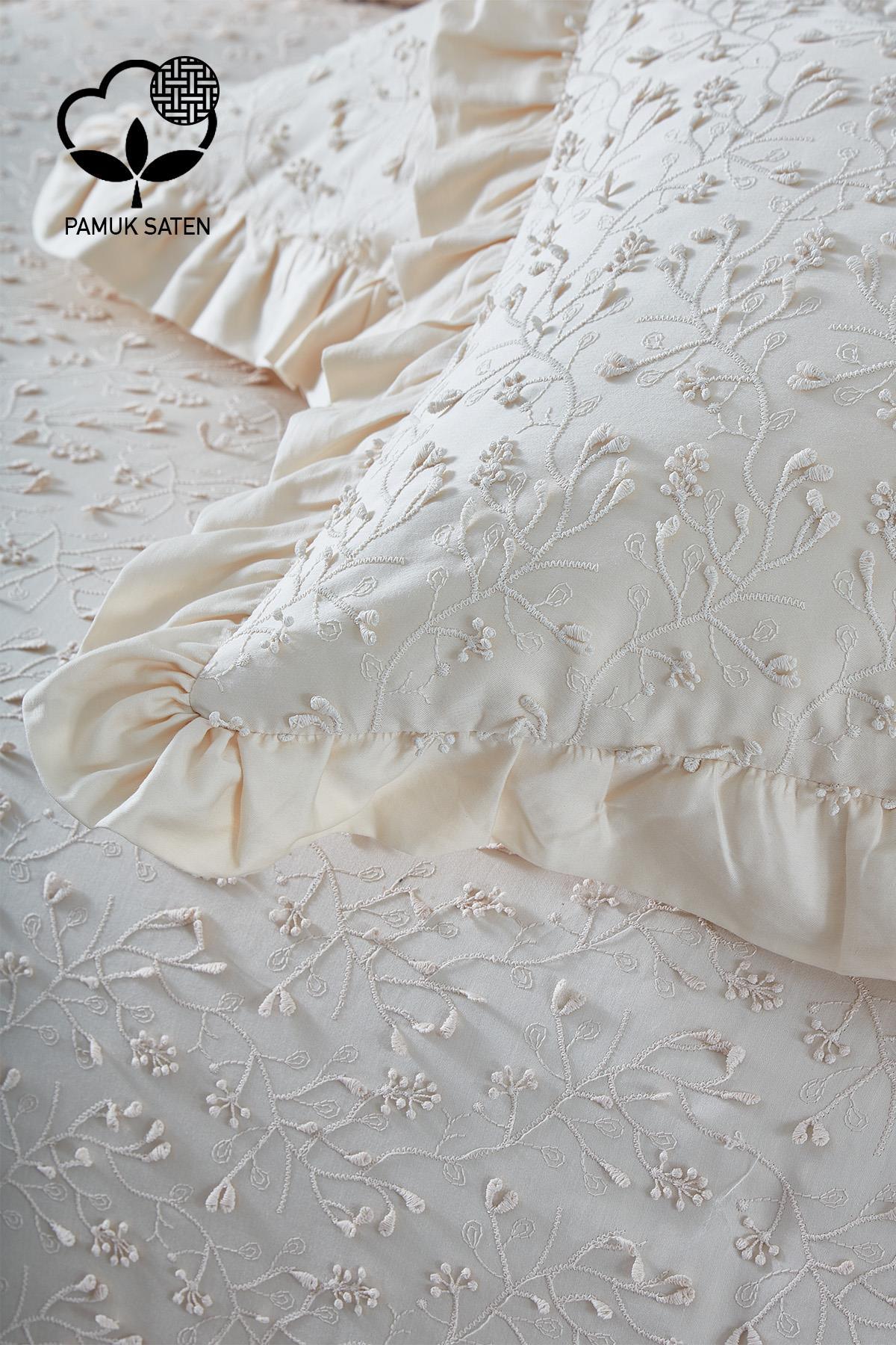 Embroidered cream cotton sateen double duvet cover set with floral pattern and ruffled pillowcases.