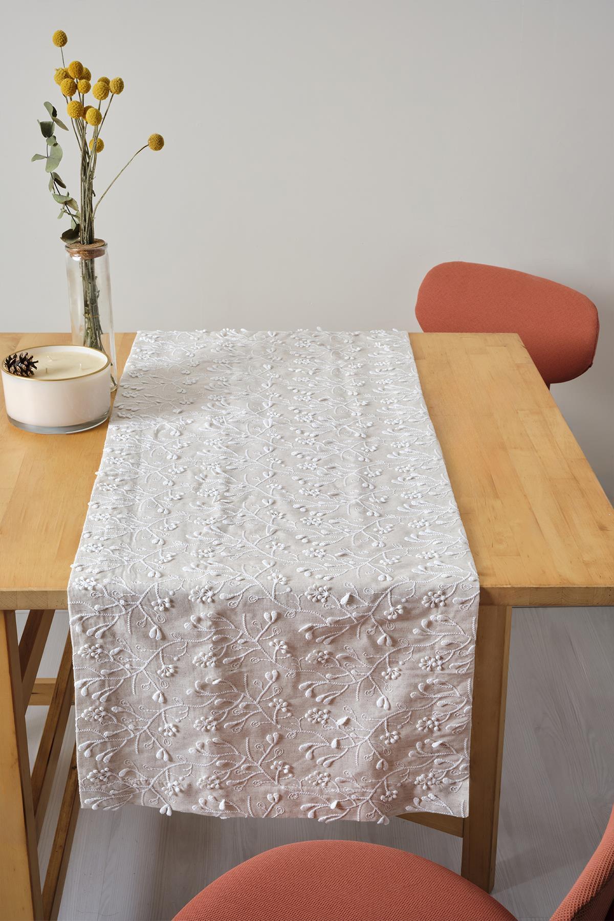 Lace-embroidered tablecloth, decorative presentation on a natural wooden table