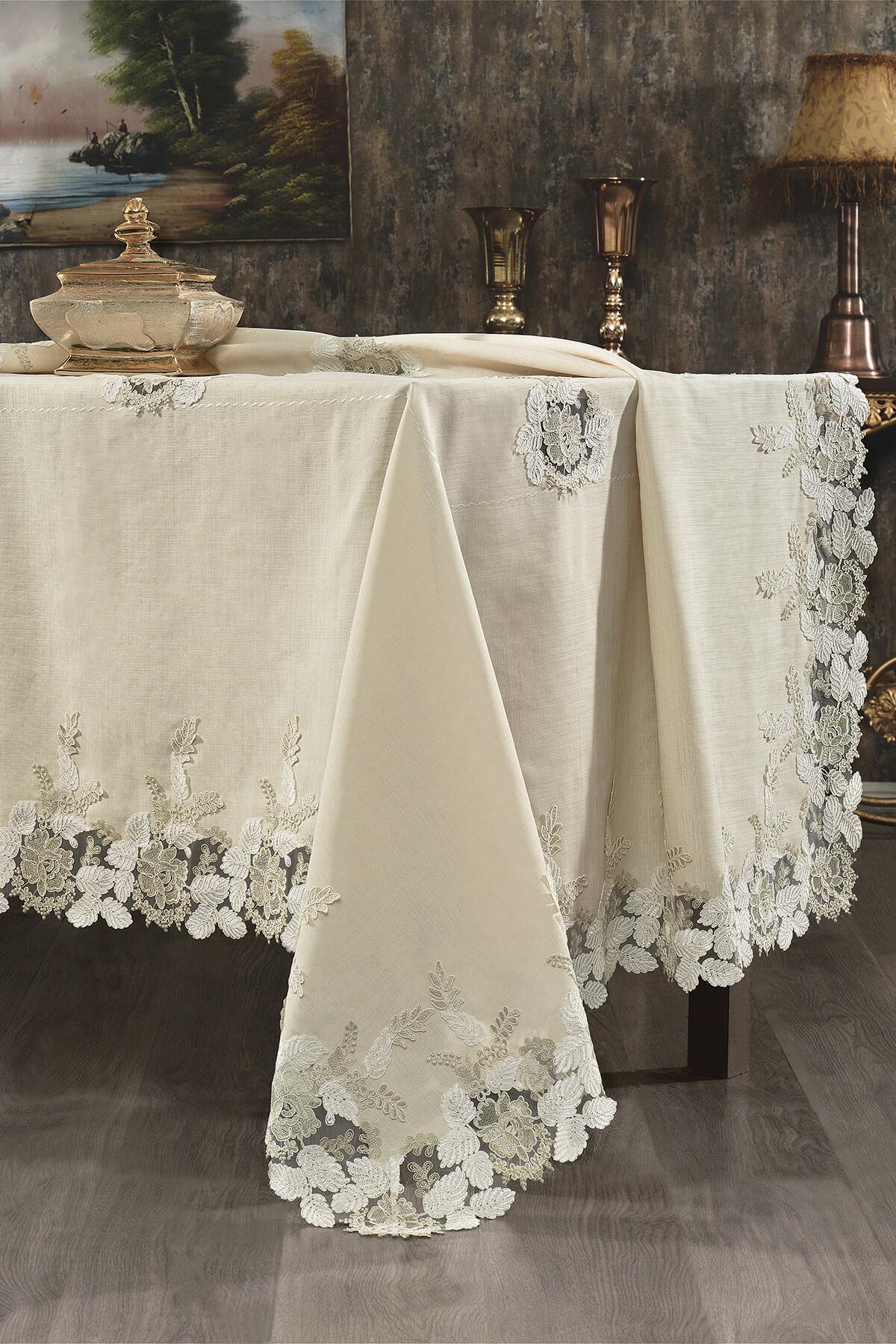 Cream-colored stain-resistant tablecloth with lace floral details, on a rectangular table