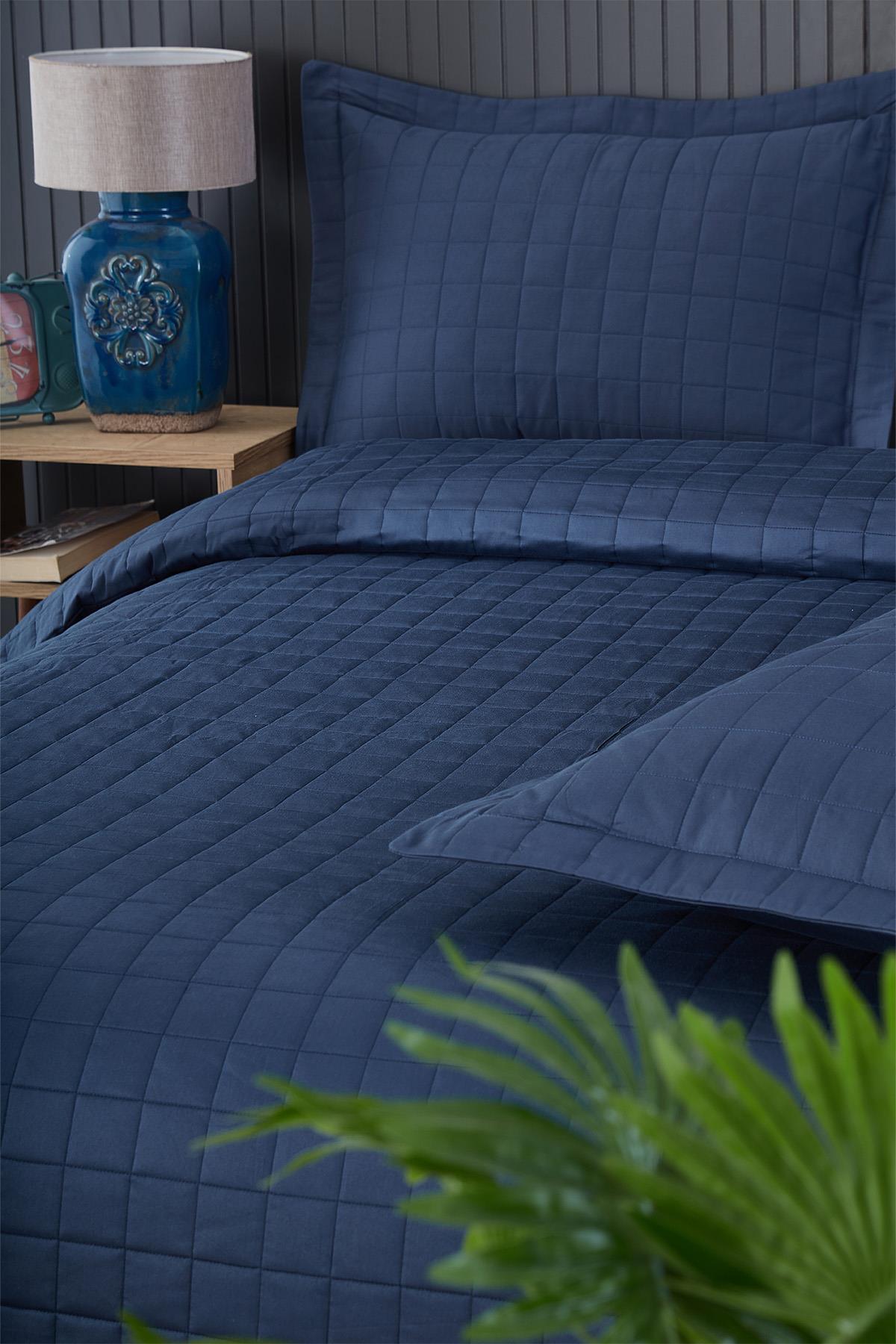 Navy blue quilted double bedspread and pillowcase, modern bedroom decor