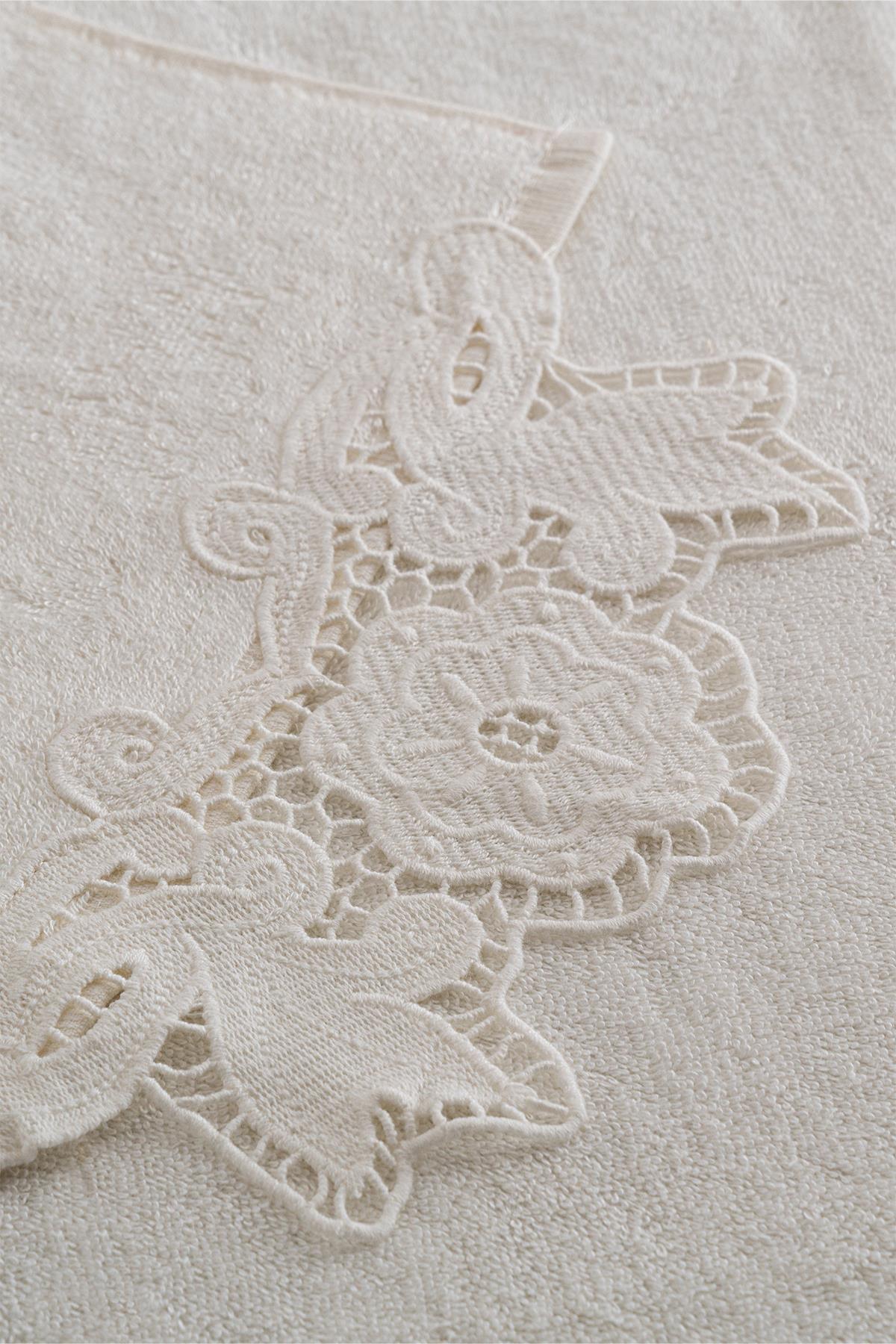 Cream-colored cotton towel with lace details, floral pattern, and a soft texture