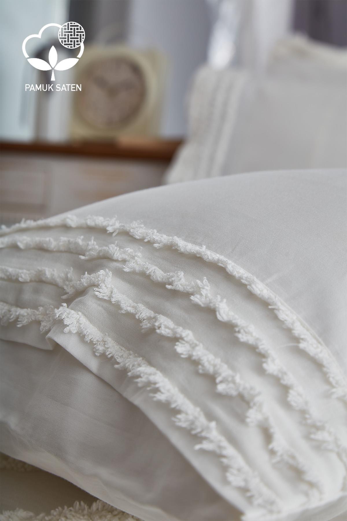 Detailed photo of white cotton sateen duvet cover set with tassels