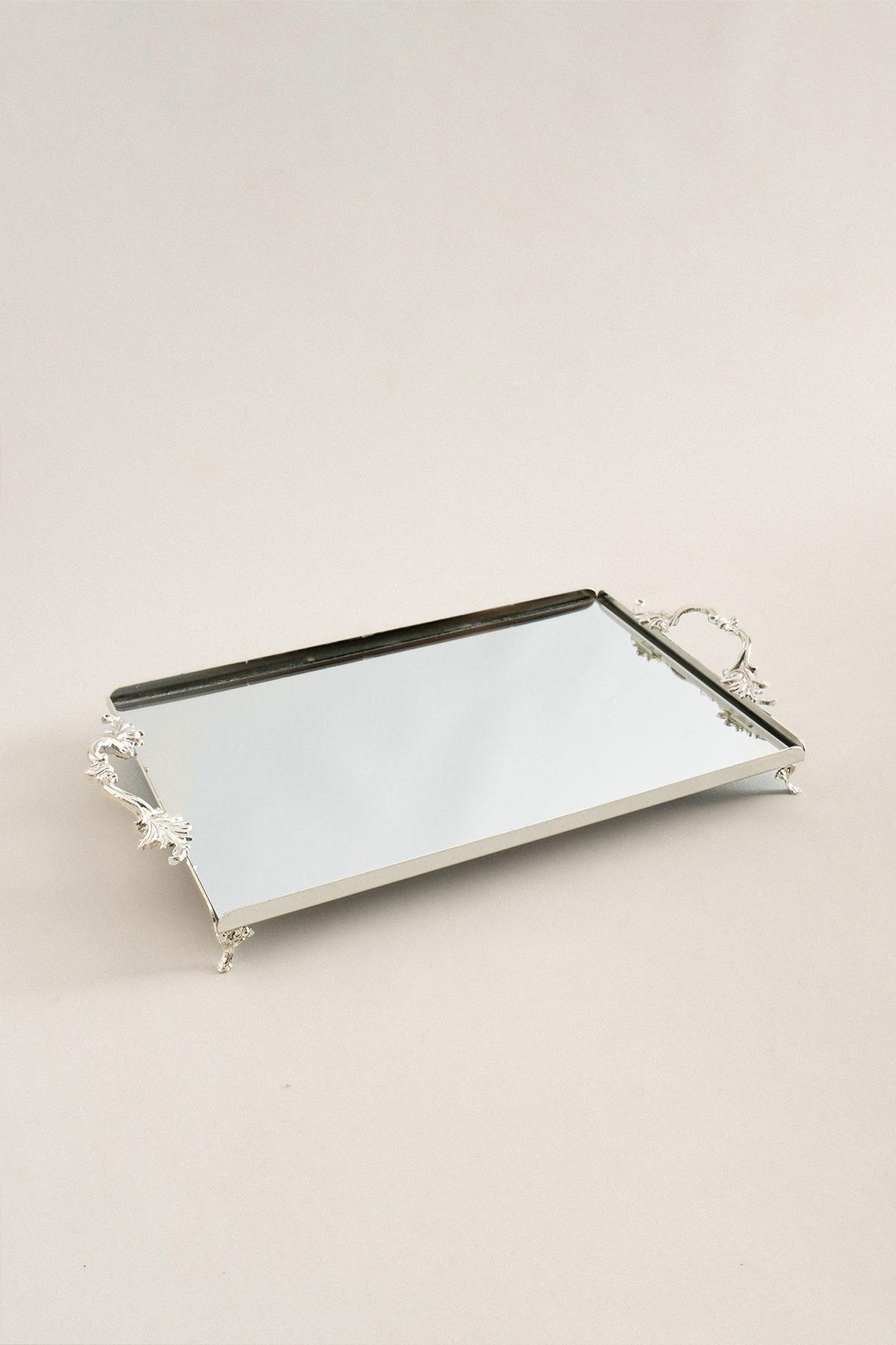 Large silver tray with elegant handles, rectangular, mirrored surface, with decorative details.