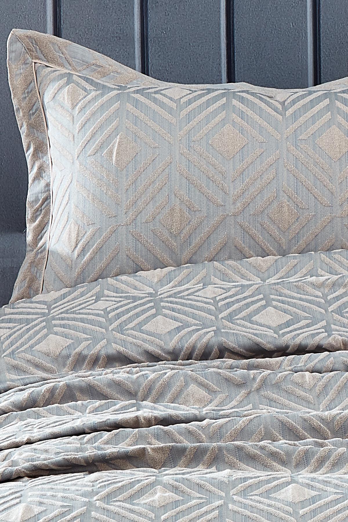 Double bedspread and pillowcase set with a grey geometric jacquard pattern.