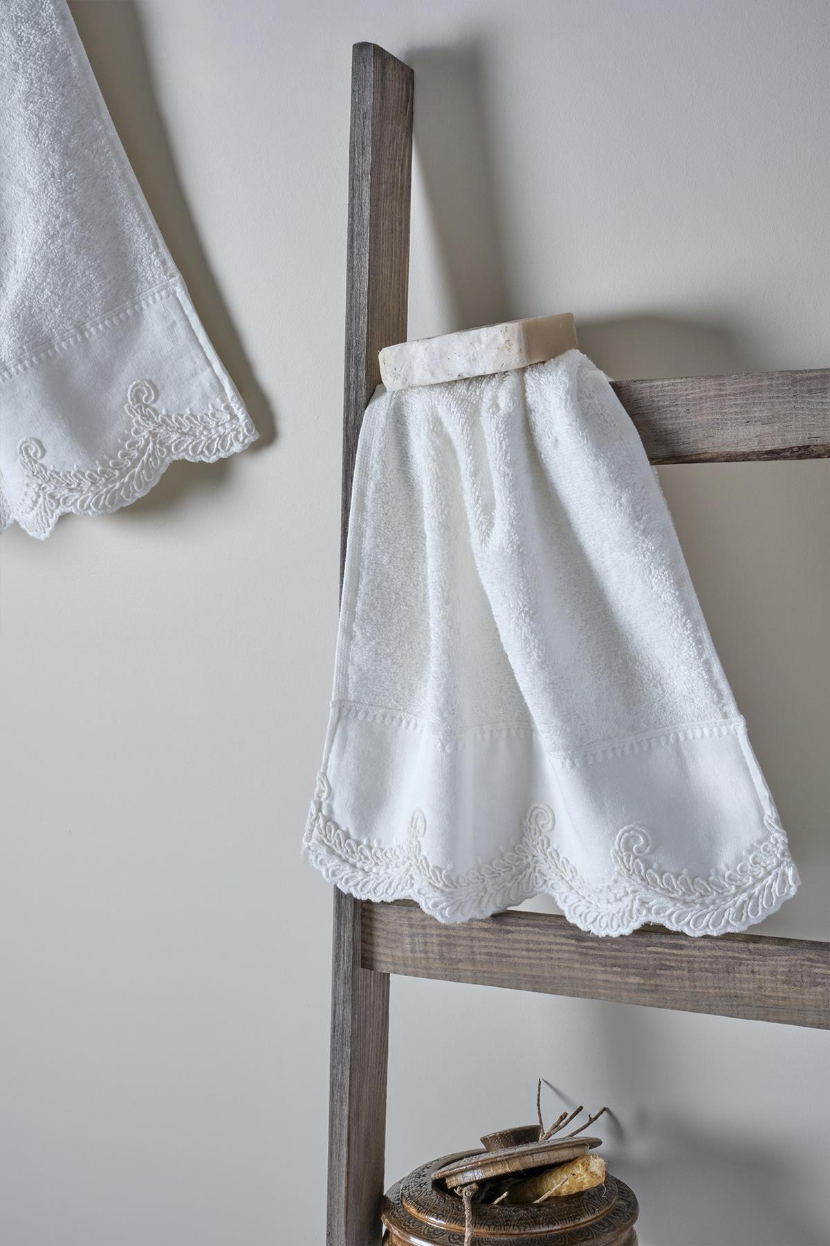White lace-embroidered body towel on a wooden ladder, featuring elegant patterned edge details