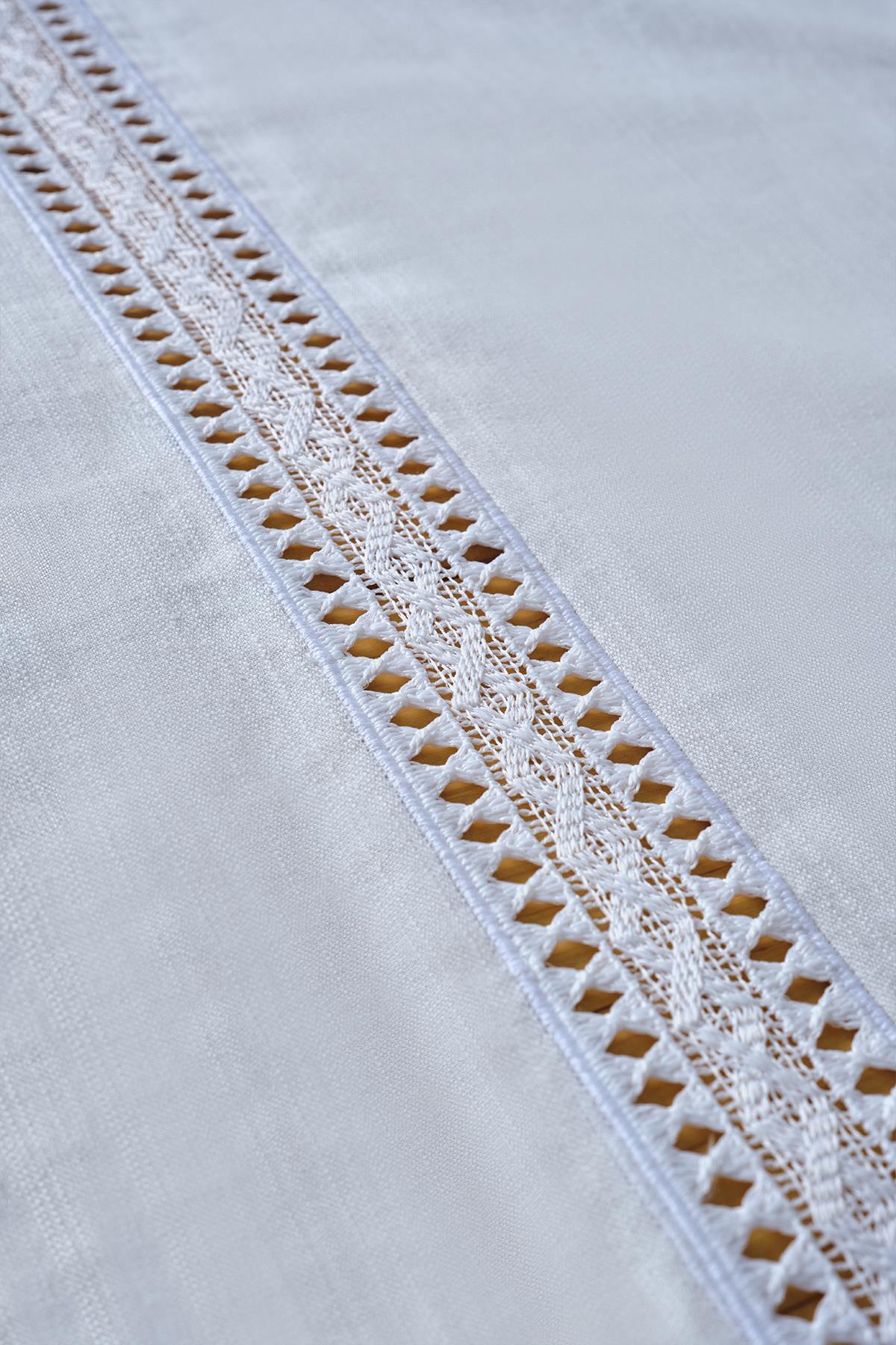 White tablecloth with lace details, an elegant and stylish table decoration product