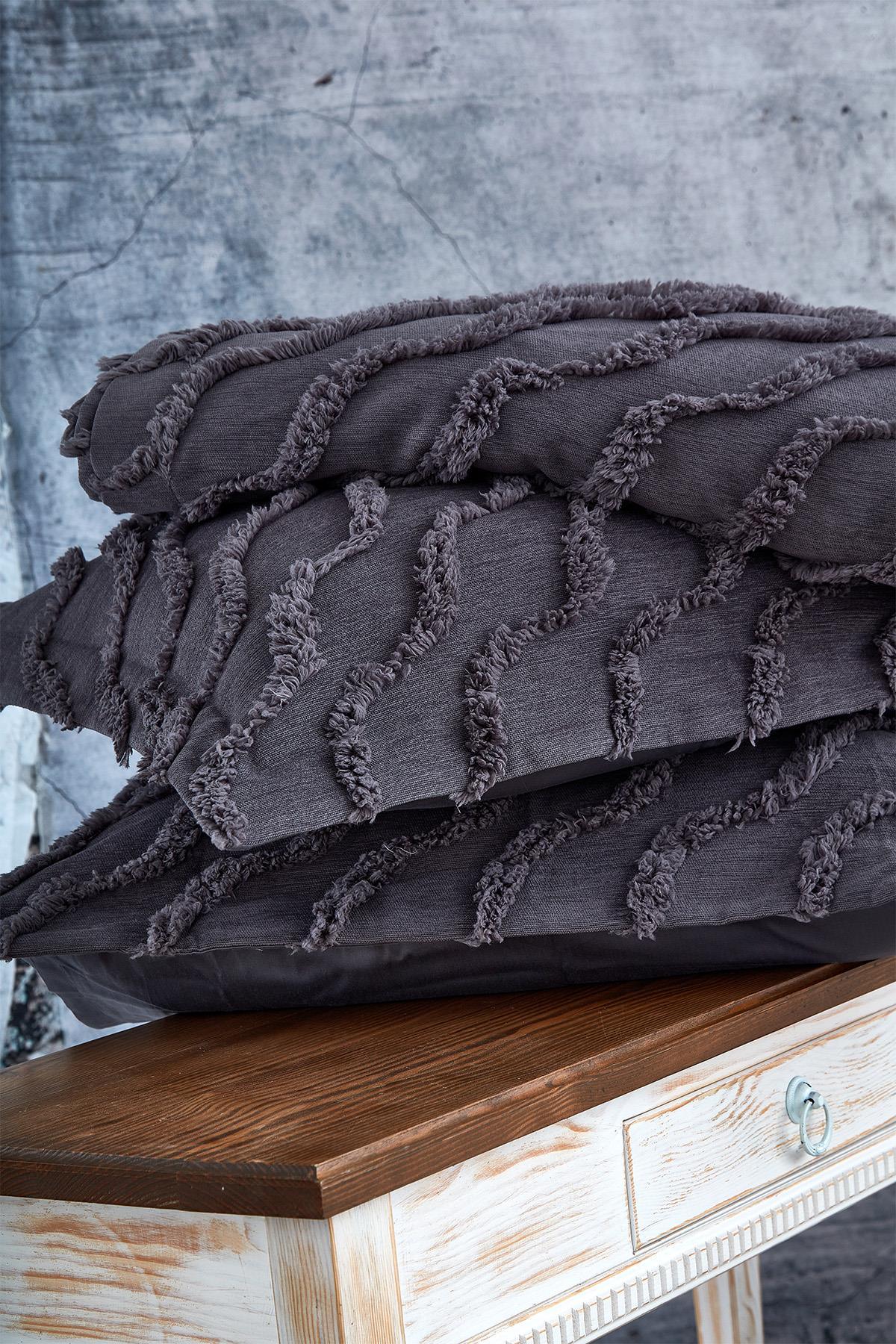Linen-textured black double bedspread on a wooden nightstand