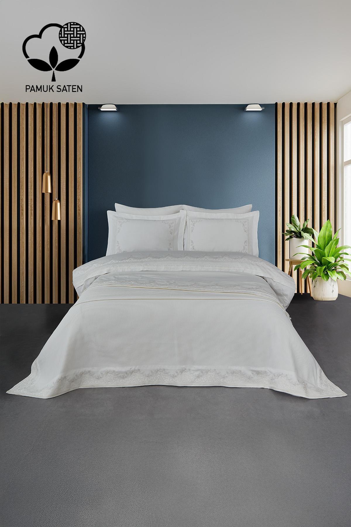 White cotton sateen double duvet cover and bedspread set with ruby embroidery, in a modern bedroom