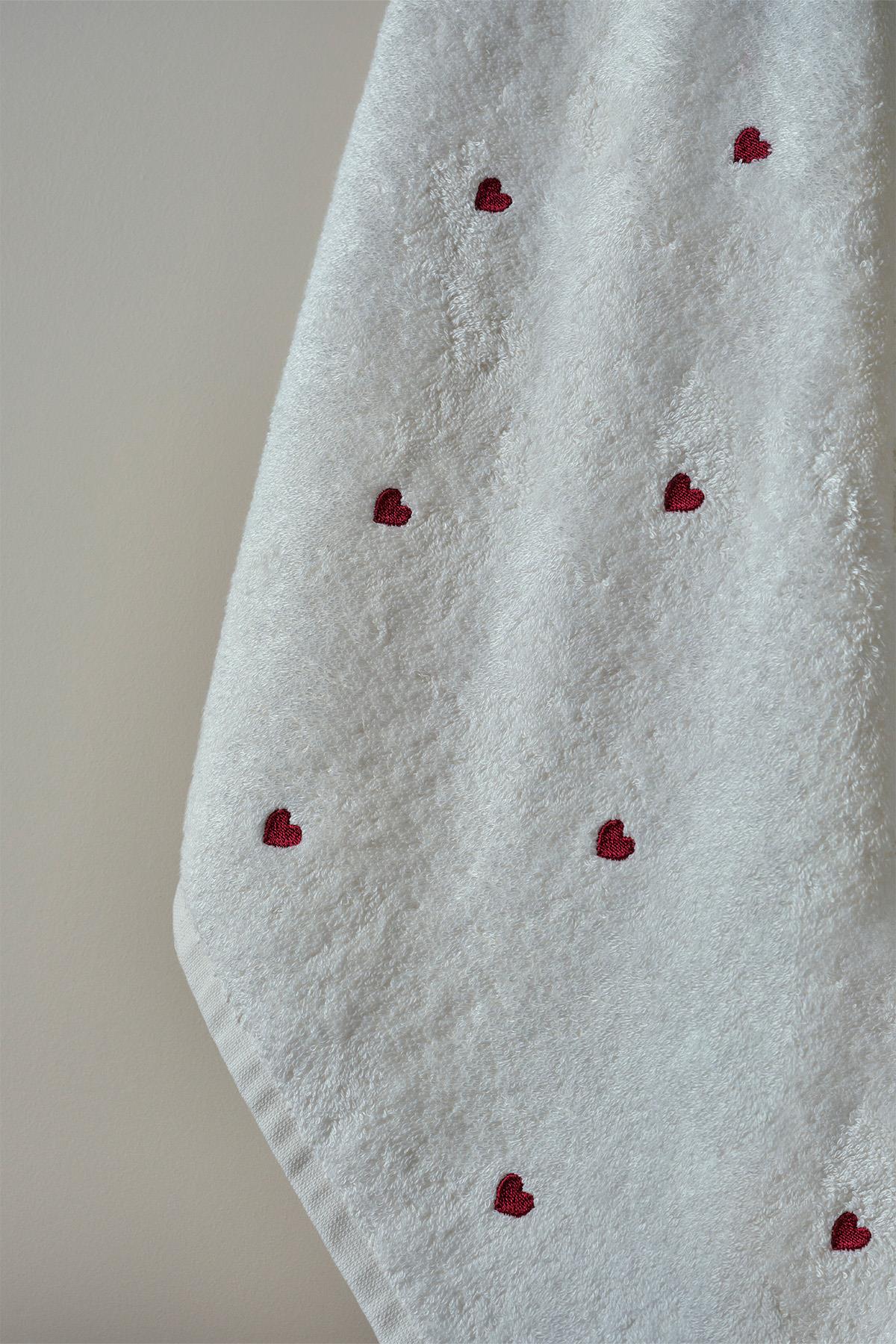 White towel with red heart patterns, stylish and comfortable