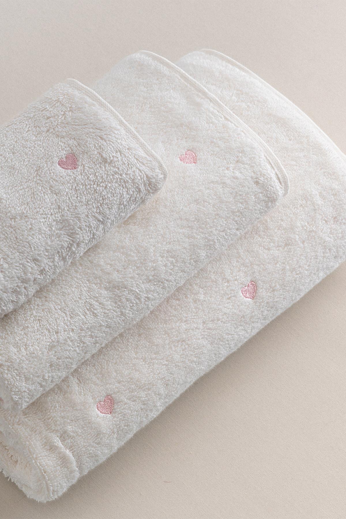 White towel set with pink hearts, soft-textured comfortable bathroom accessory