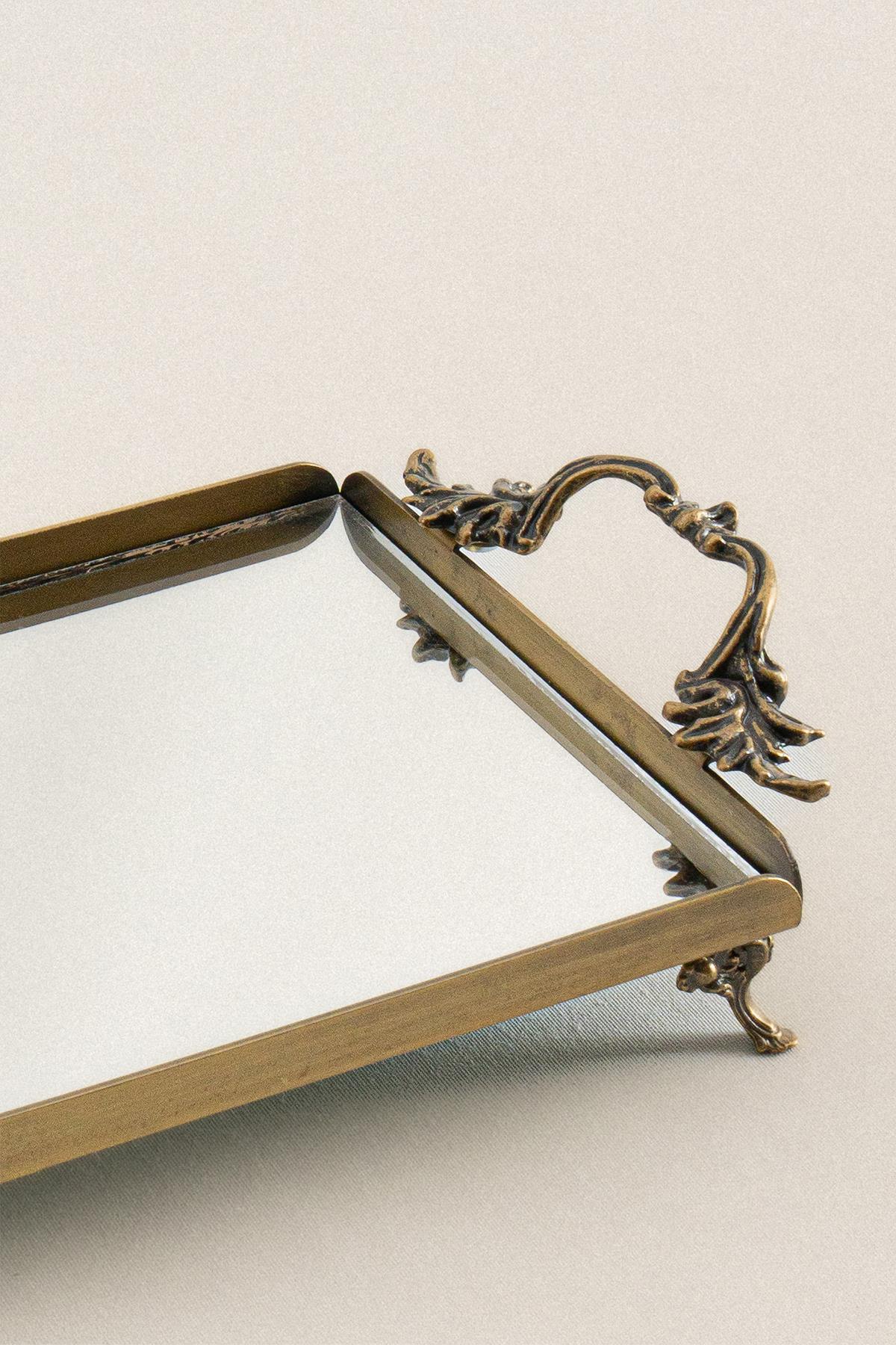 Mini metal tray with an elegant handle and a distressed finish, rectangular and decorative.