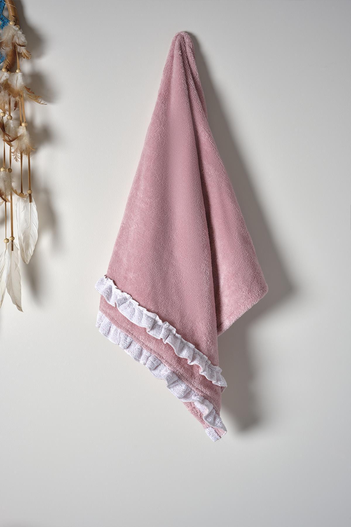Pink women's bathrobe with lace trim, hanging on the wall, cotton bath textile