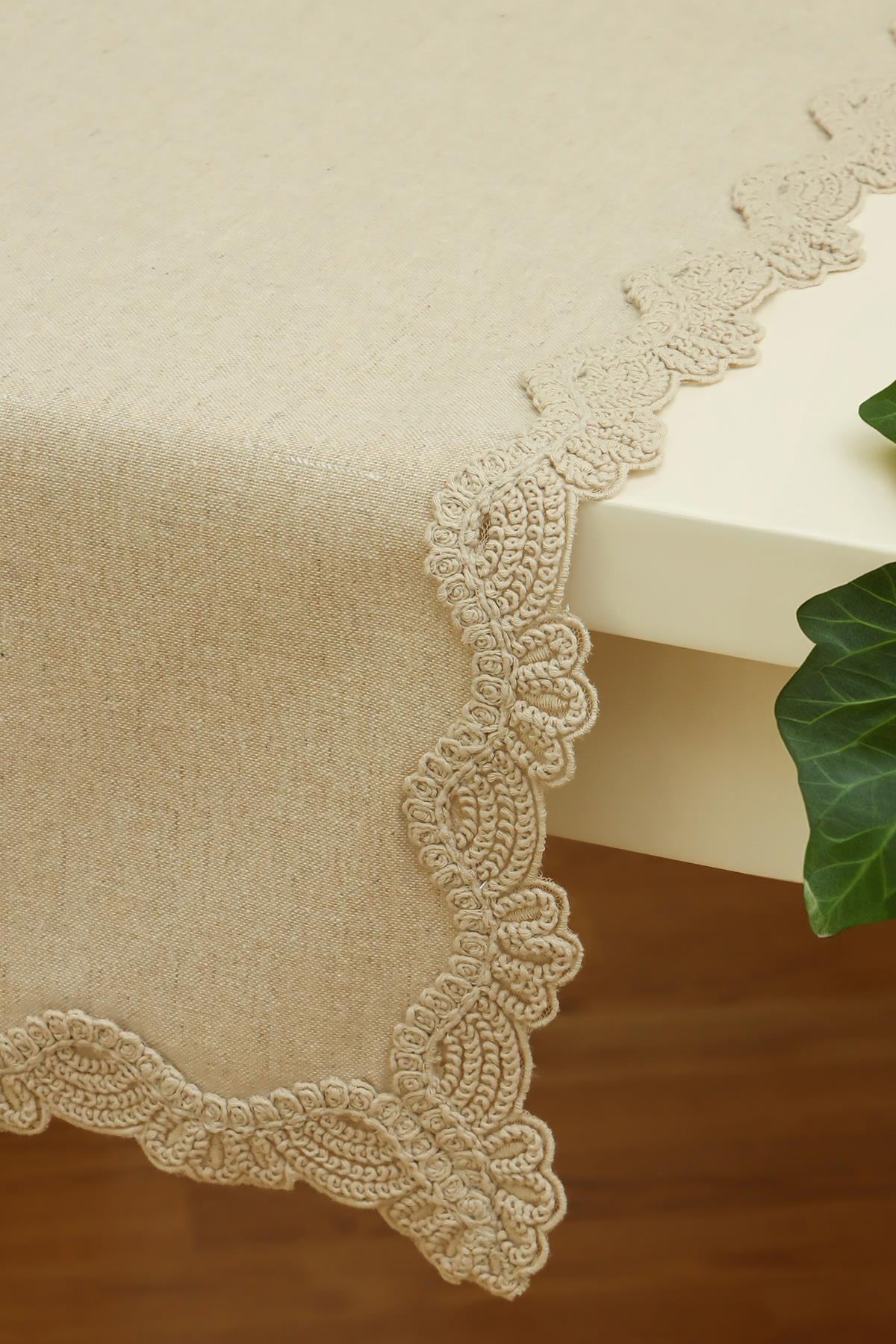 Cream-colored lace-edged tablecloth on a rectangular table